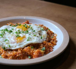 a plate of food on a wooden table