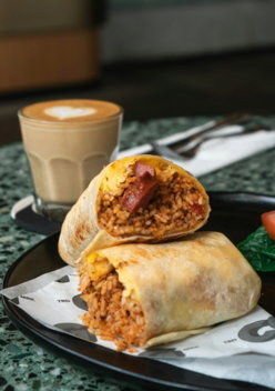 white ceramic mug beside brown bread with red sauce